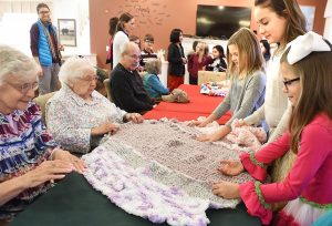 Suncrest Elementary's Crochet Club gives blankets to nursing home residents